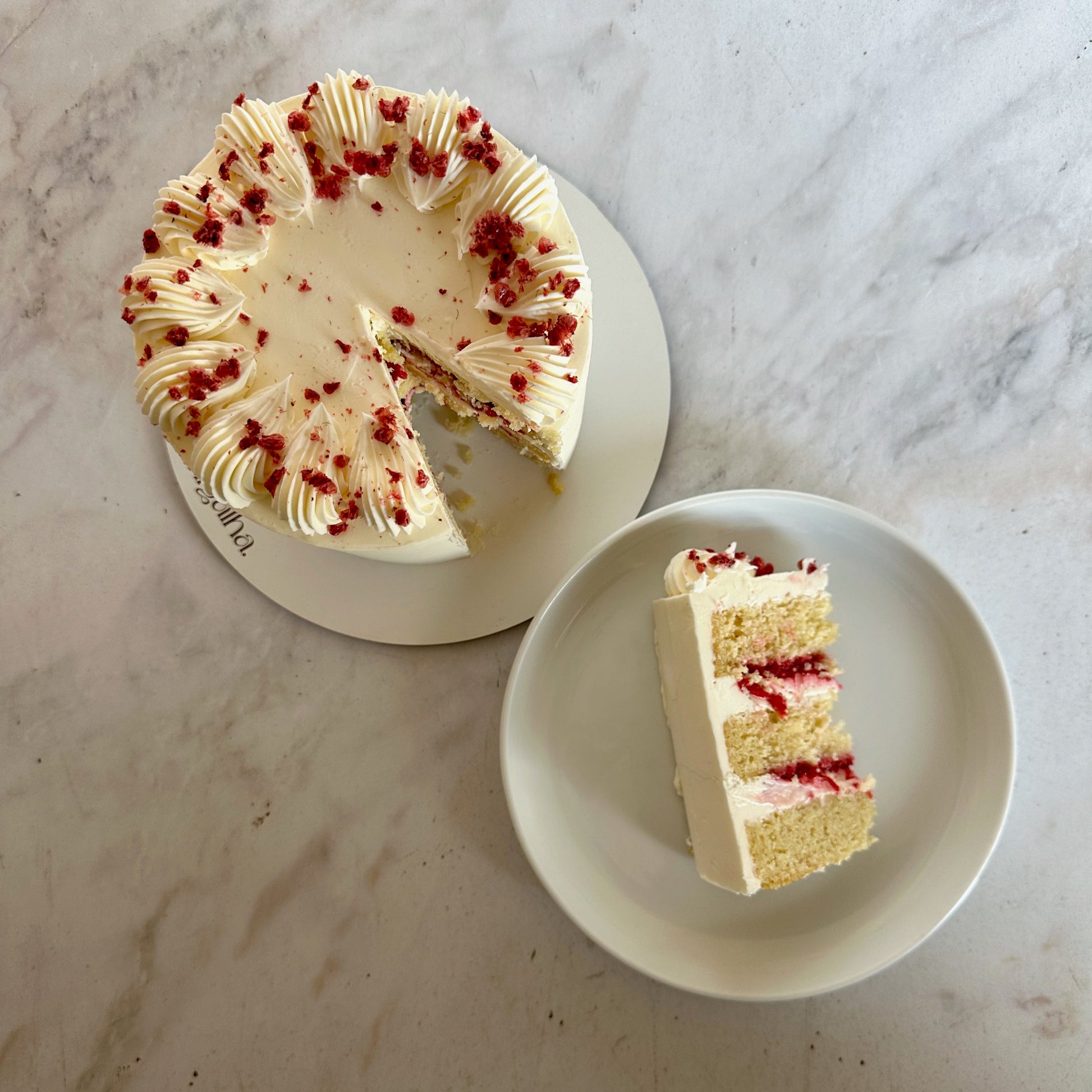 Raspberry couli and white chocolate ganache filled cake slice