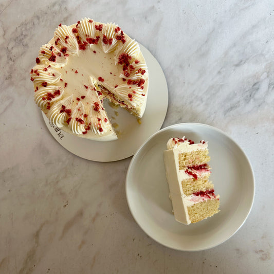 Raspberry couli and white chocolate ganache filled cake slice